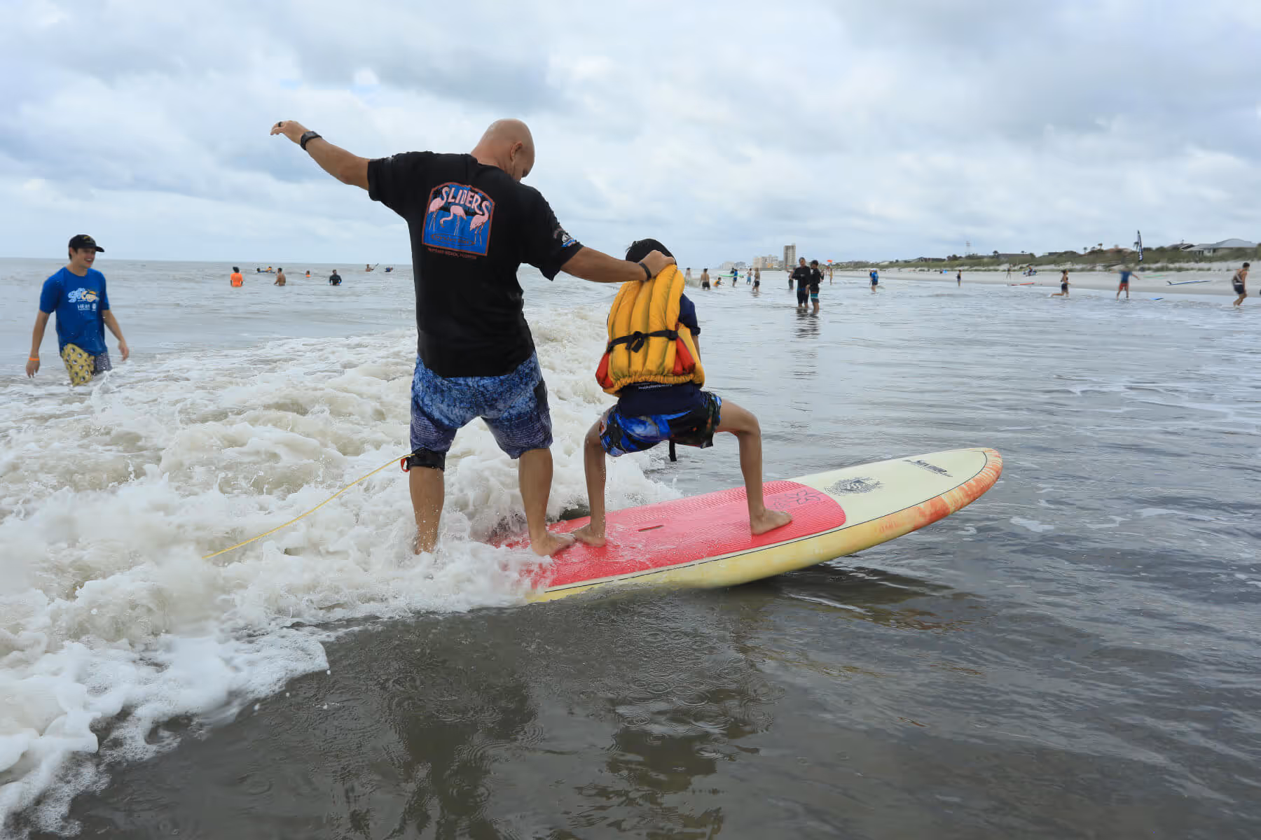 2019 Surf Camp Volunteer and Child Standing