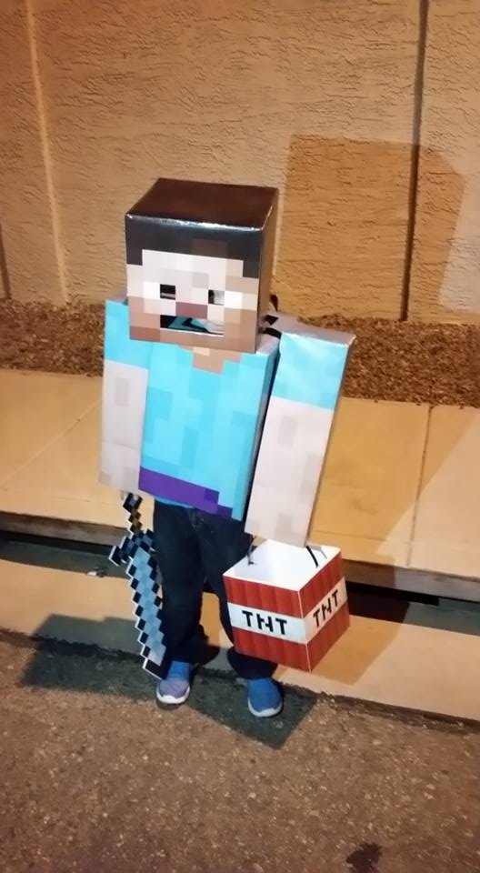 A photo of my homemade Minecraft Steve costume for my 8 year old son made from cardboard and printed skins
