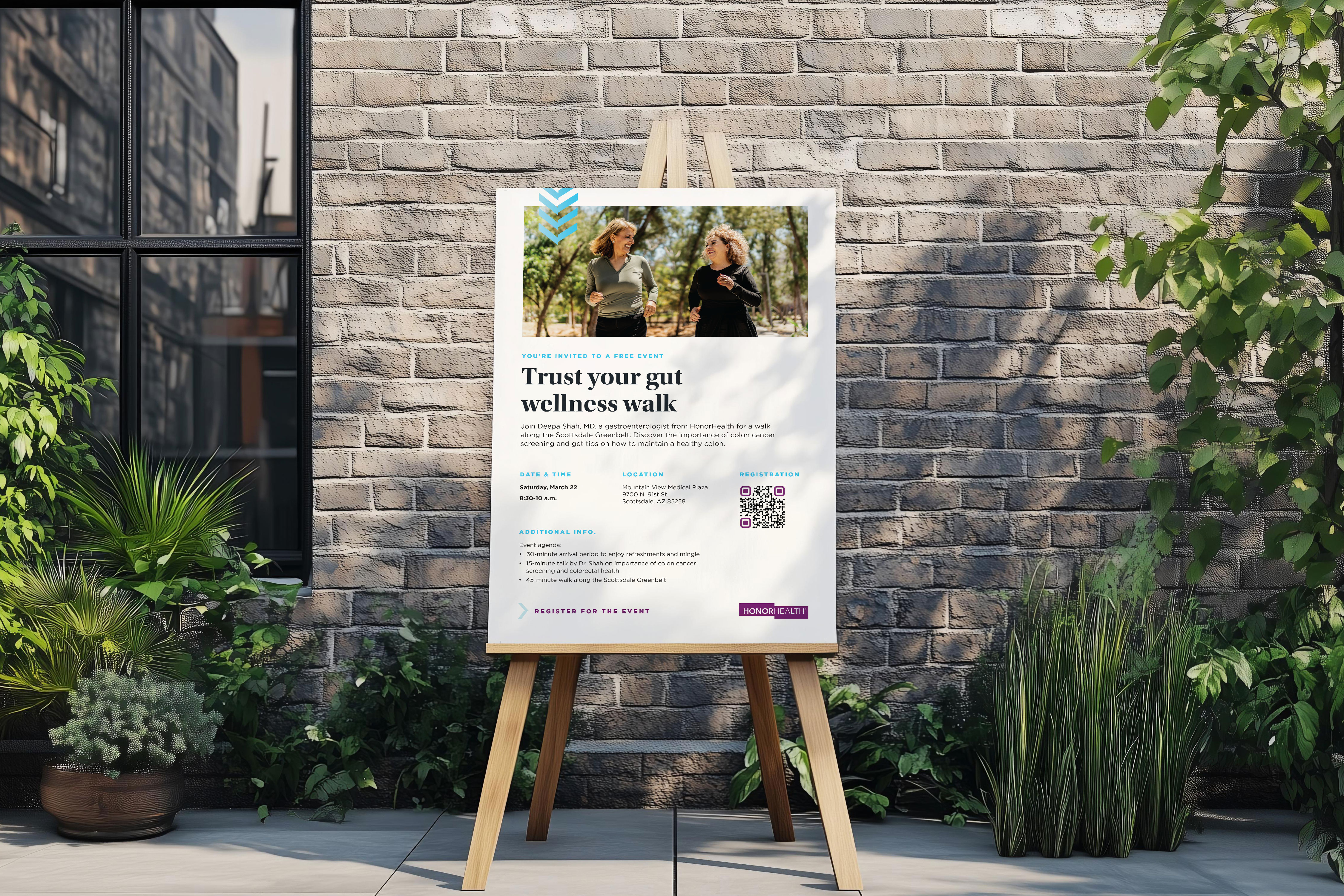 Poster on easel against brick wall promoting a free wellness walk event focused on gut health with two women jogging in a park image at the top.