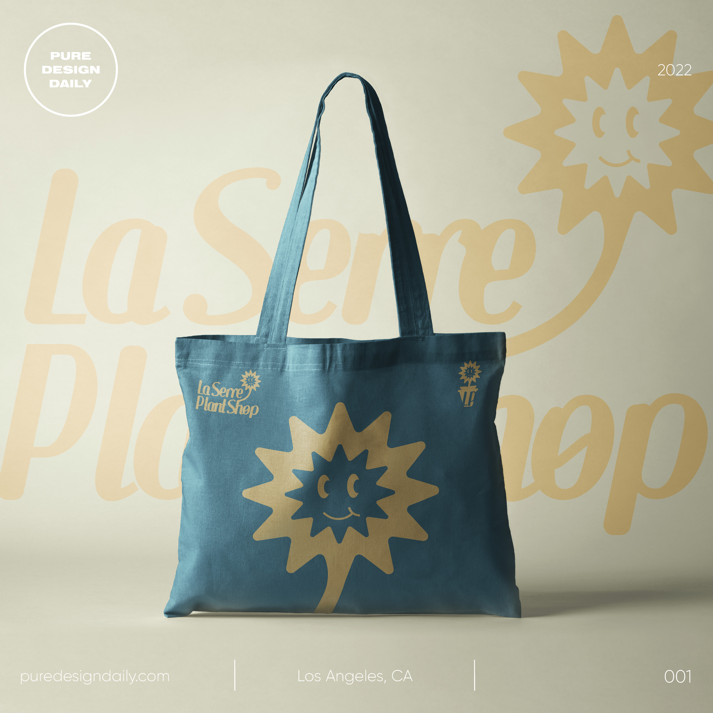 Blue tote bag with smiling sun flower graphic and text 'La Serre Plant Shop' on a beige background.