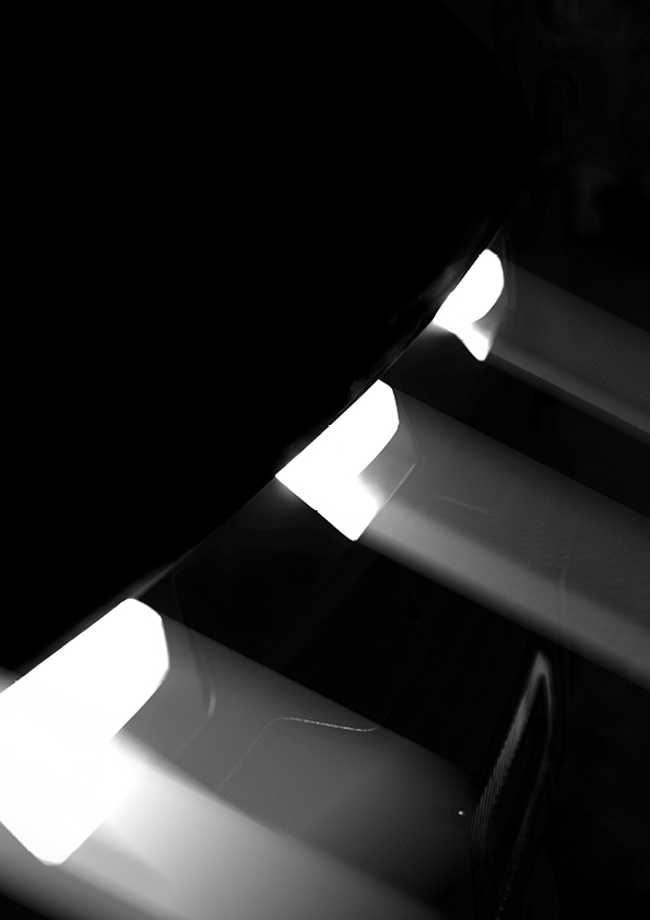 Close-up black and white image of piano keys with light streaks creating a glowing effect.