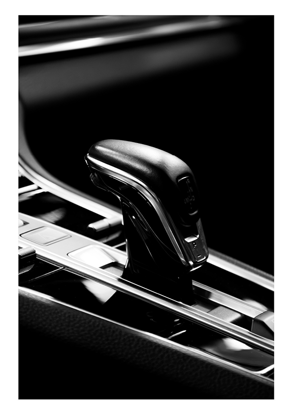 Close-up of a modern car gear shift lever in black and silver with 'P' for park visible.