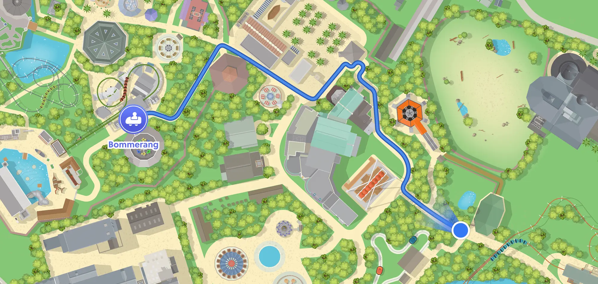 Colorful theme park map with paths, trees, rides, and a blue route guiding to the Bommerang attraction.