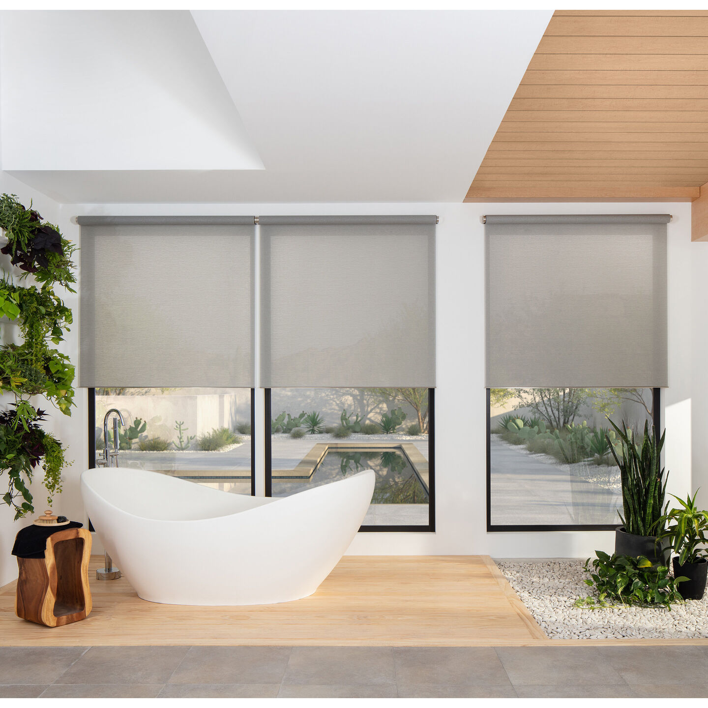 Lutron Palladiom wired roller shades in a modern bathroom with three aligned windows