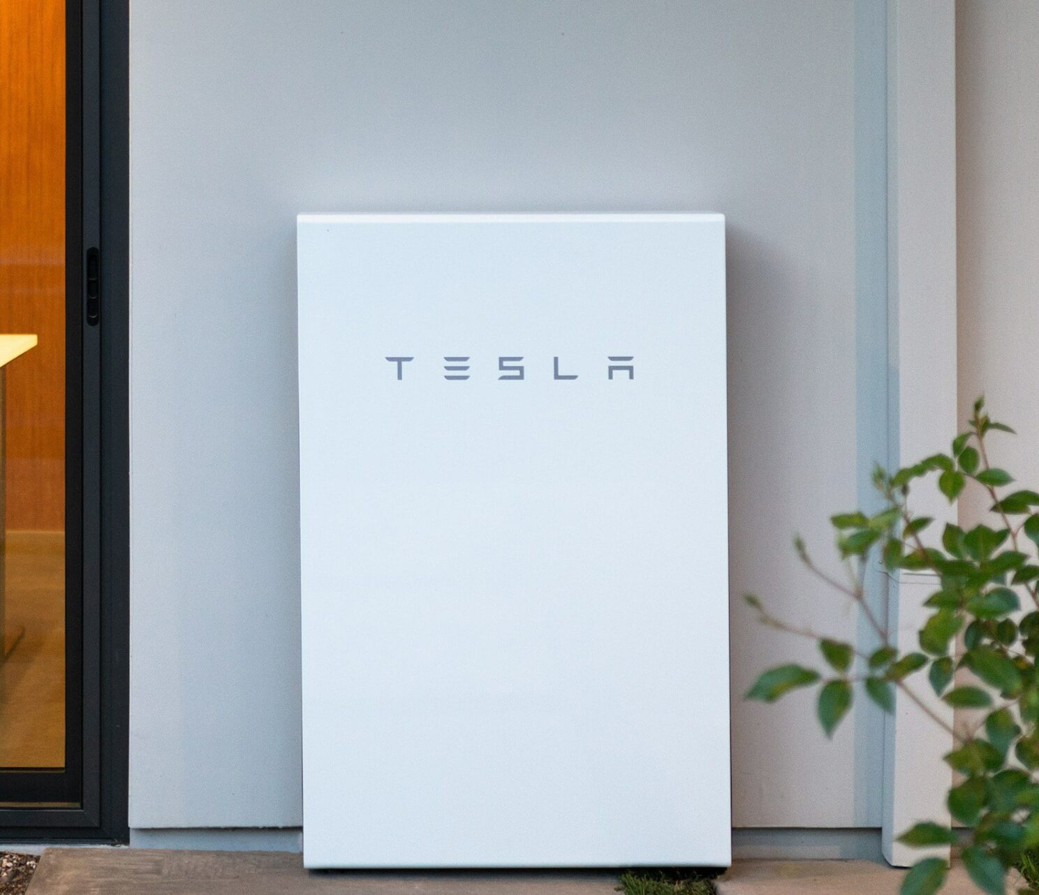 Residential battery storage installation beside exterior electrical equipment