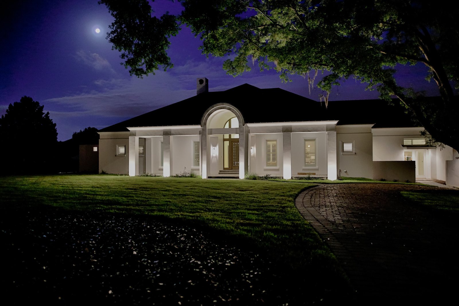 Residence with warm architectural exterior lighting at night