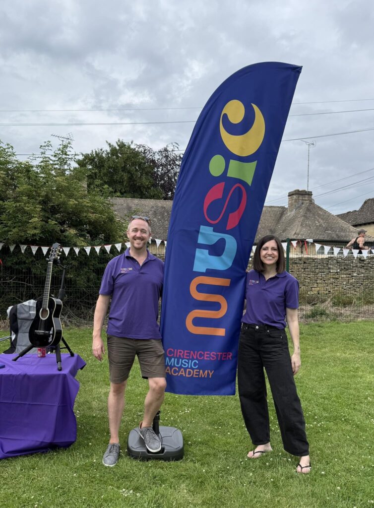 Stuart and Nicki Elwin with a Cirencester Music Academy flag during a launch event.