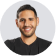 A man in a black shirt is smiling.