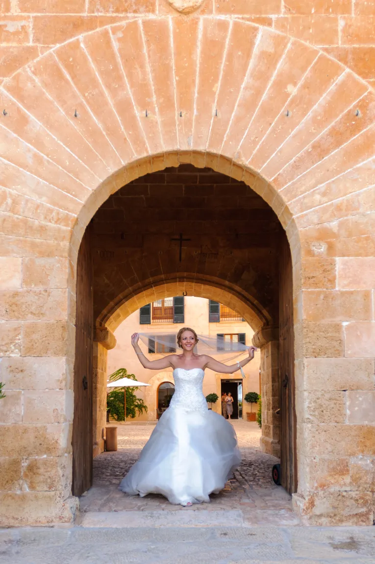 Bride in doorway holding veil at Zoetry Majorca by by Andrew Hazard wedding photographer 