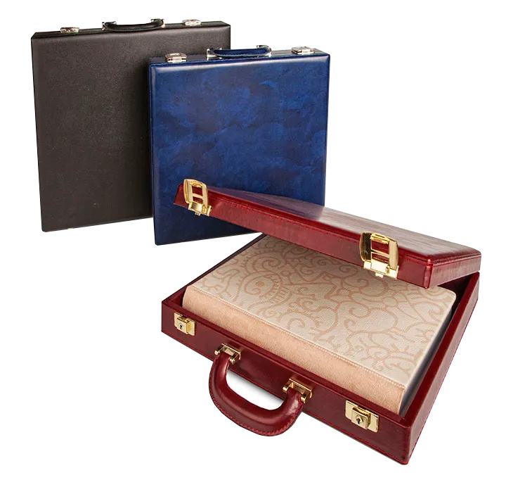 Three leather briefcases in black, blue, and open red showing beige patterned fabric inside.