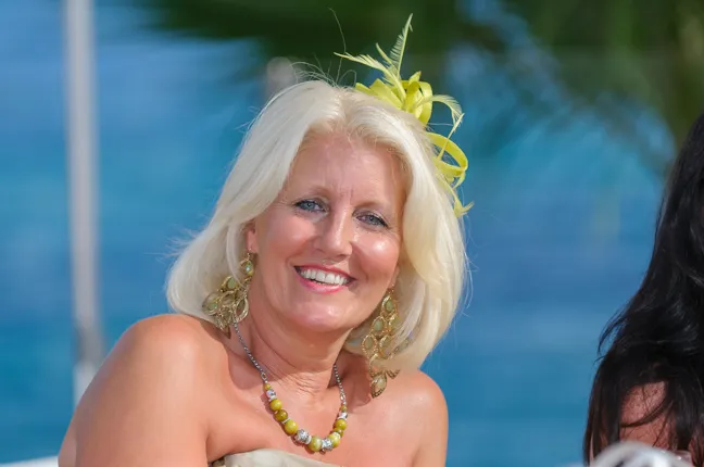 Guest relaxing at a wedding at Um Beach House, Portals, Majorca  with marina in background by Andrew Hazard Photography