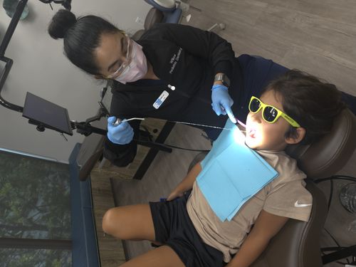 girl smiling getting teeth examined