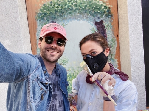 Emily Kolodny and David Kolodny standing in front of Emily's mural in Hayes Valley, San Francisco