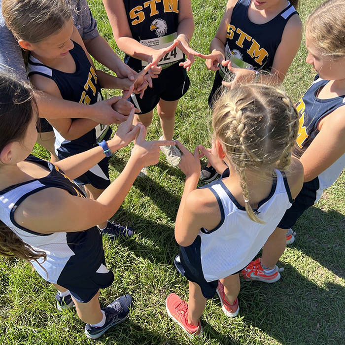 Students huddle before a cross country event