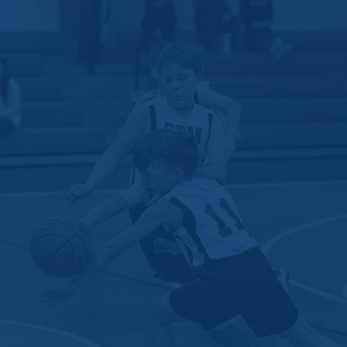 Students playing boys basketball