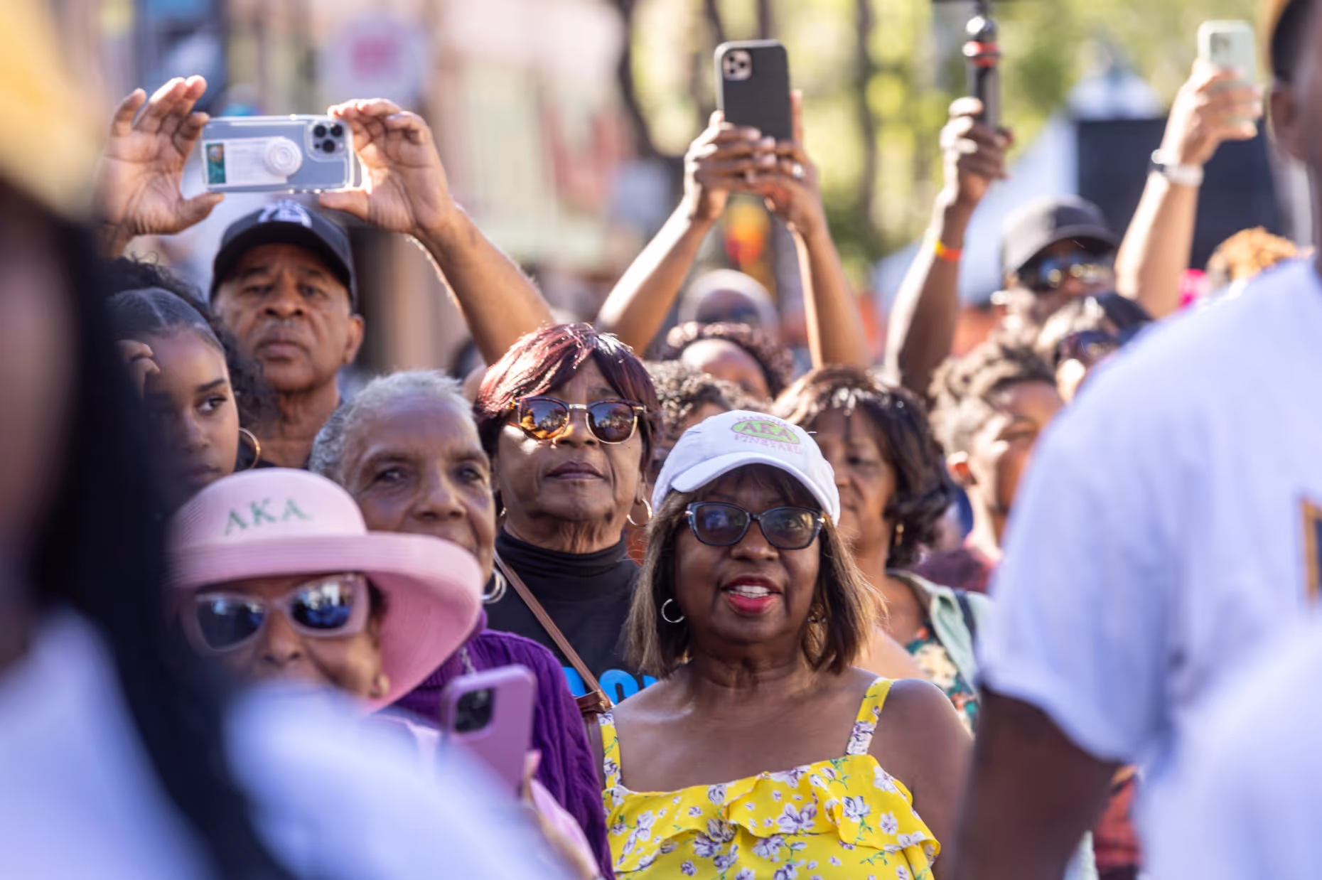 Festival-goers hold up phones to record the performance.