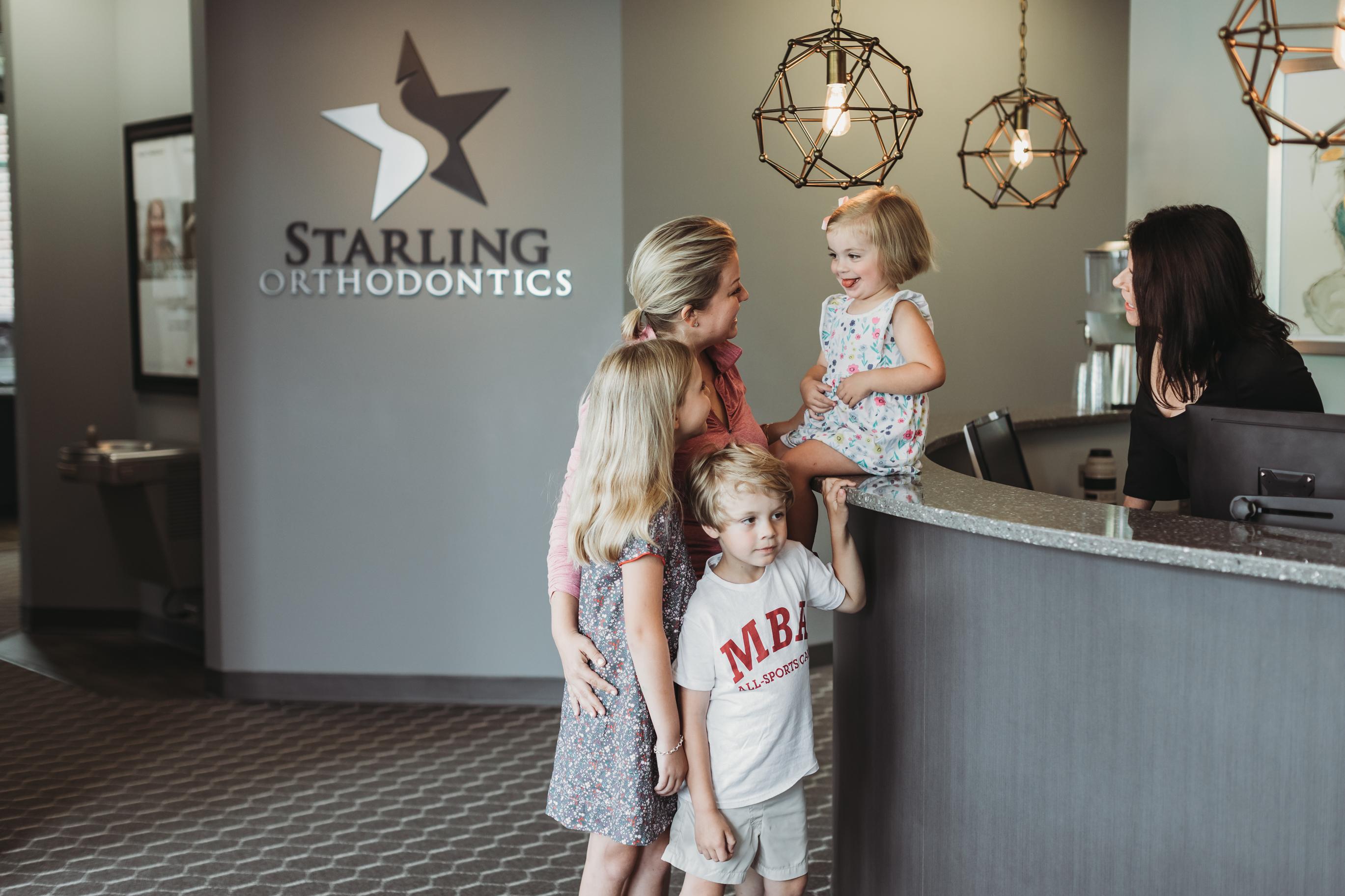 A parent and child are together into a modern dental office, creating a warm and welcoming atmosphere for their dental visit. This pediatric dental office specializes in providing expert care for children's oral health, ensuring a positive experience for families in the Nashville area.