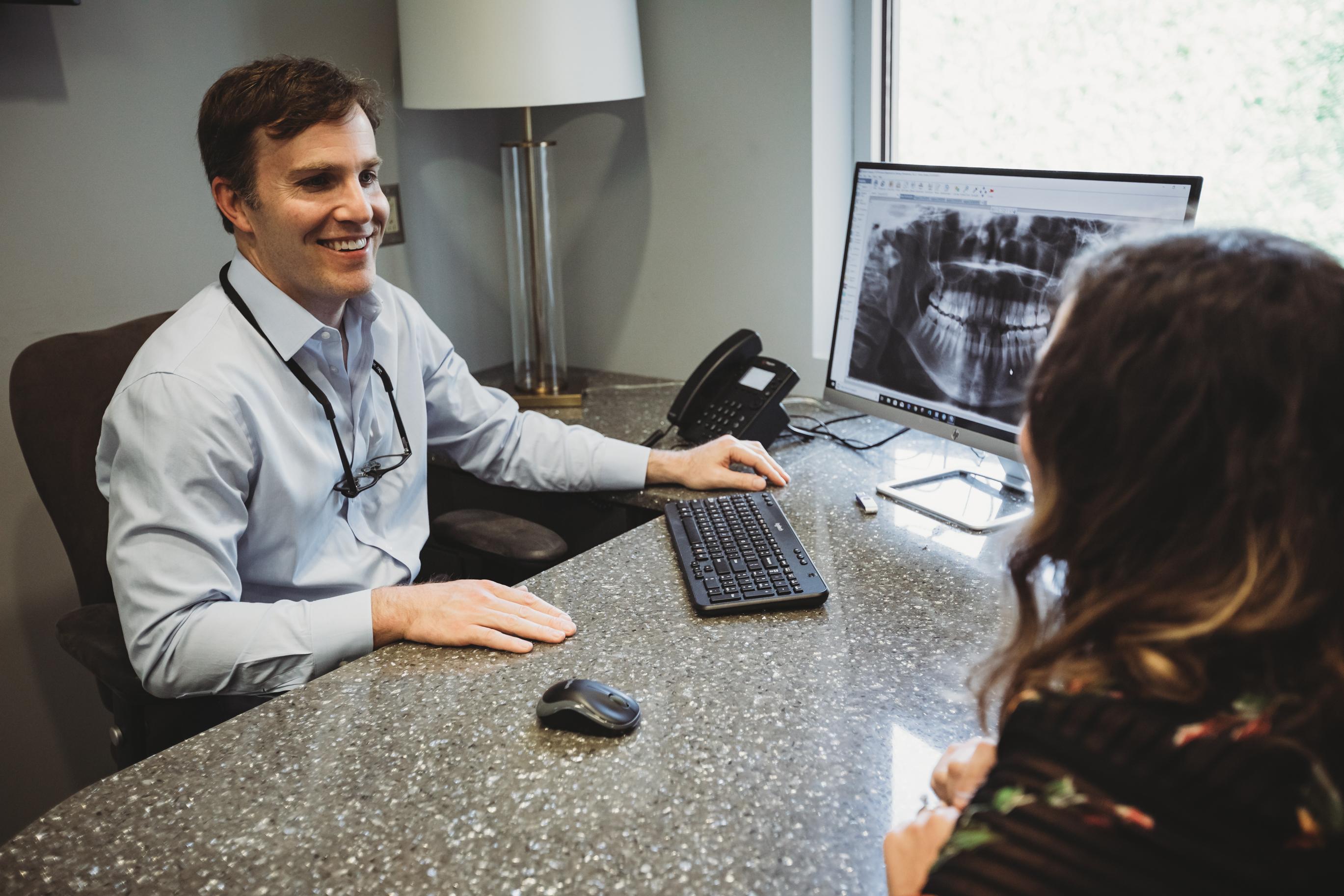 Brentwood Orthodontist Dr. Craig Starling with adult lingual braces patient in consultation room
