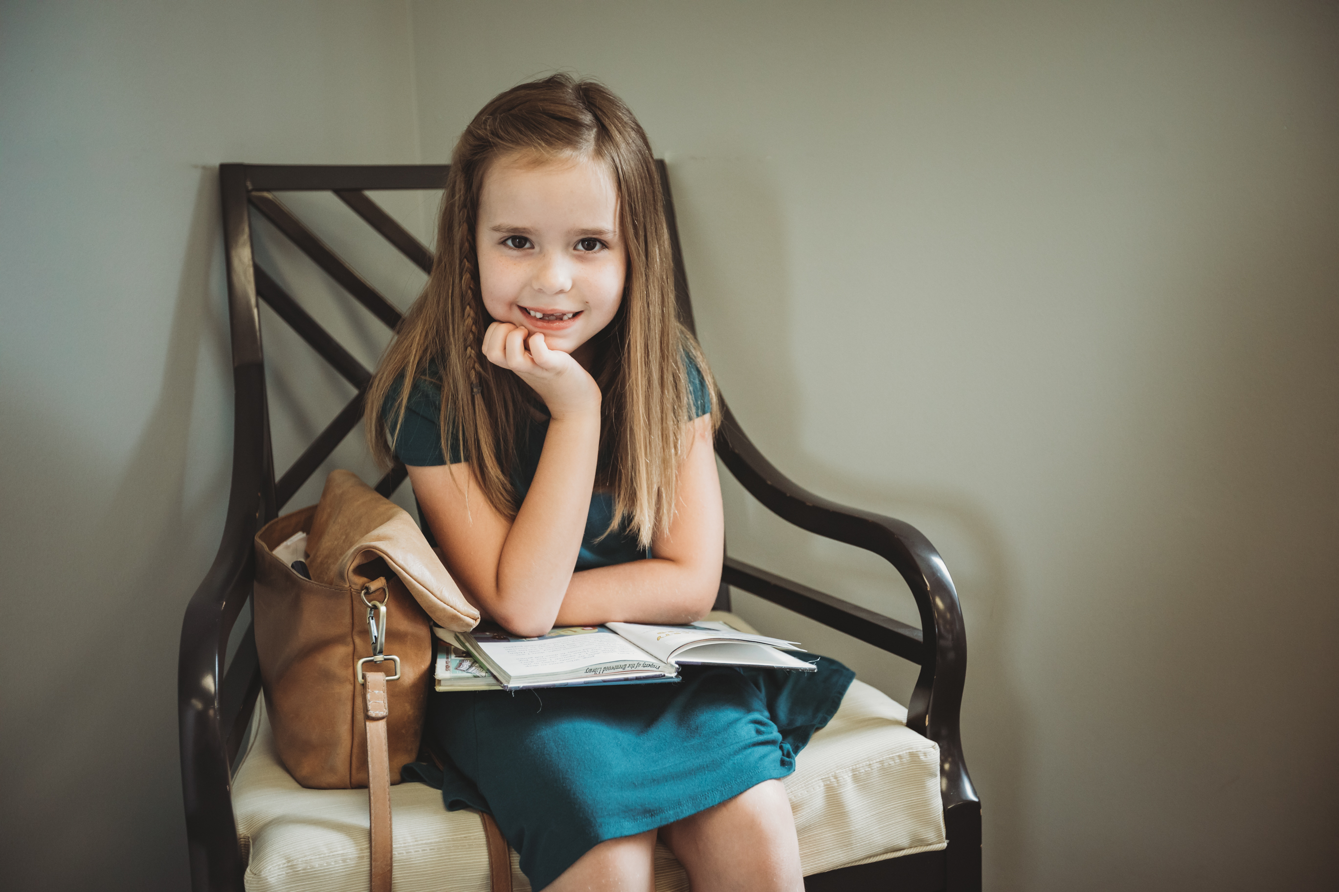 Young girl with a missing baby tooth smiling in the waiting room at Starling Orthodontics in Brentwood, TN