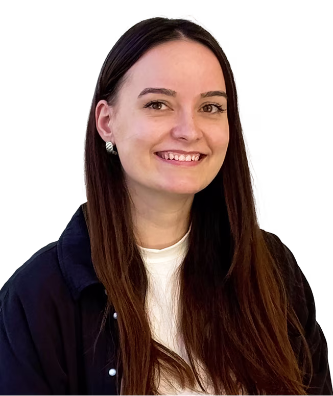 Smiling woman with long dark brown hair, wearing silver earrings and a dark blazer over a white top.