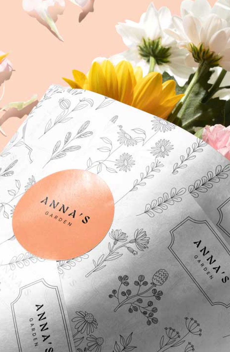 A bouquet of flowers wrapped in custom printed wax tissue paper