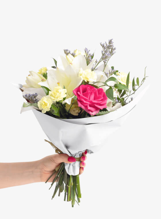 A hand holding white wax floral tissue paper
