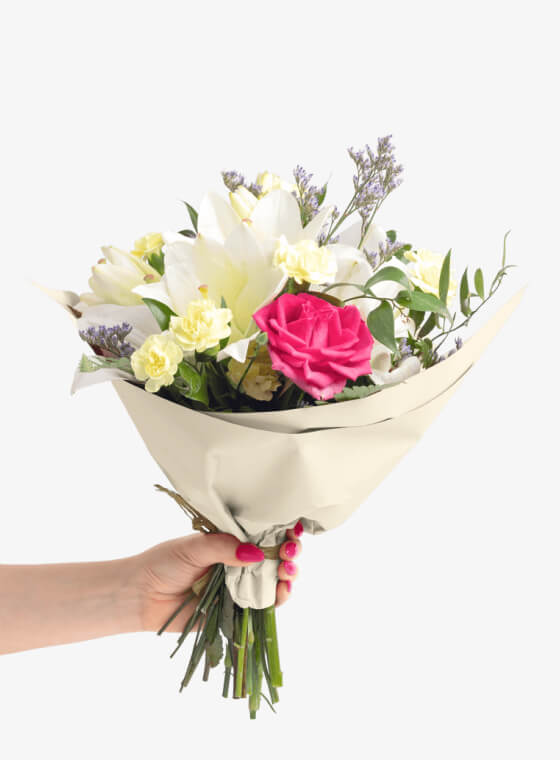 A hand holding french vanilla wax floral tissue paper
