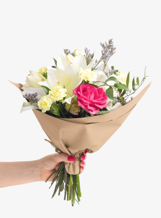 A hand holding natural kraft wax floral tissue paper