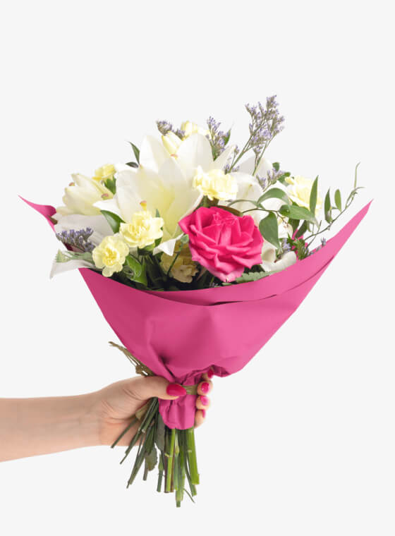 A hand holding bright pink wax floral tissue paper