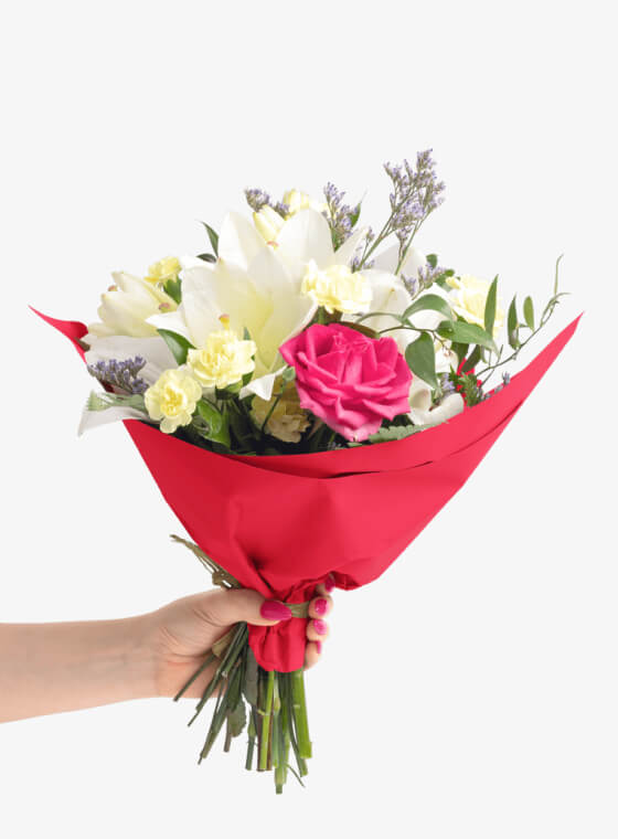 A hand holding red wax floral tissue paper