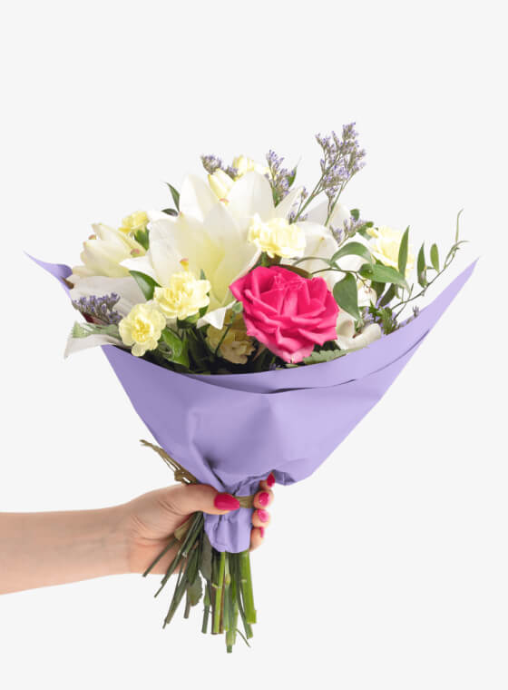 A hand holding light purple wax floral tissue paper