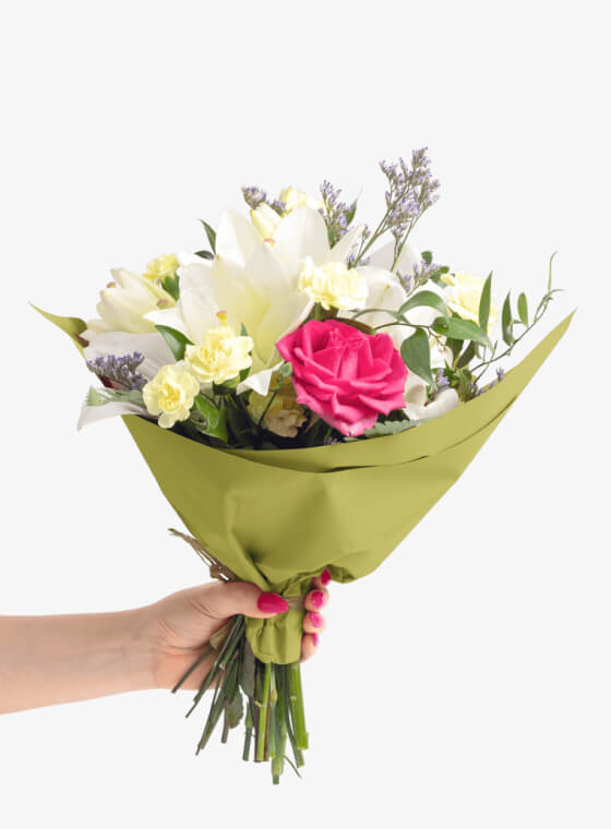 A hand holding light green wax floral tissue paper