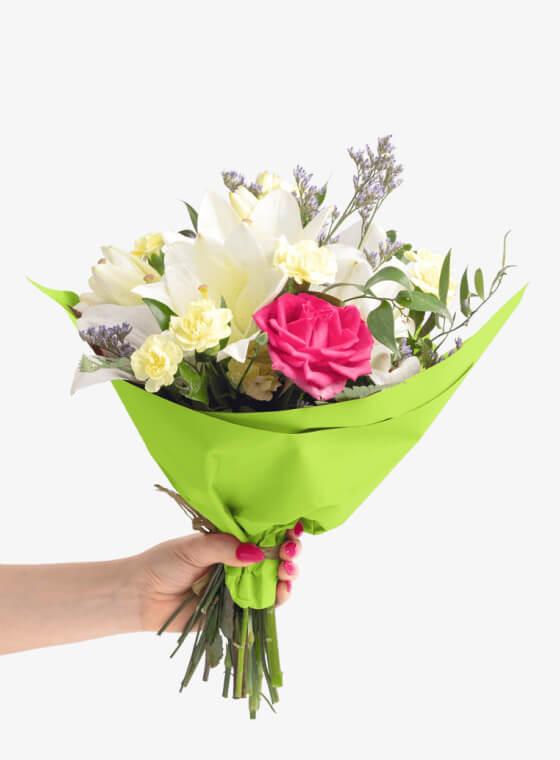A hand holding bright green wax floral tissue paper