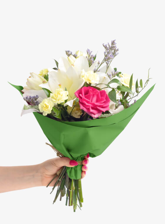 A hand holding dark green wax floral tissue paper