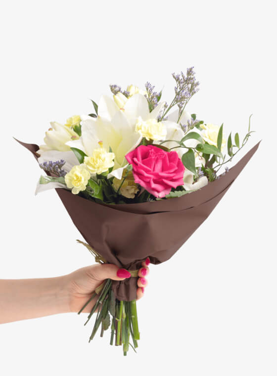 A hand holding chocolate brown wax floral tissue paper