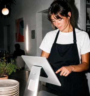 Trabajadora de restaurante gestiona pedidos desde el TPV de Last.app
