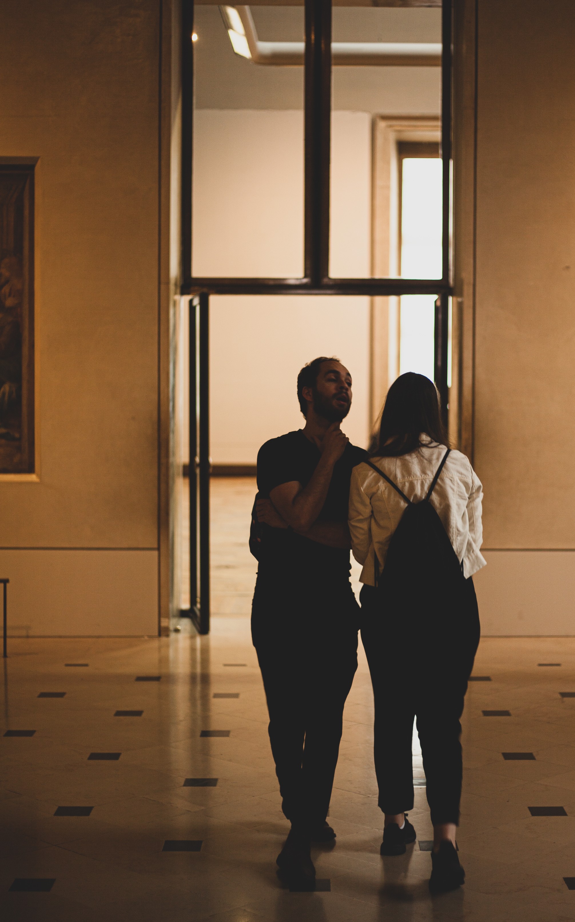 A couple walking through the Louvre Museum, Paris