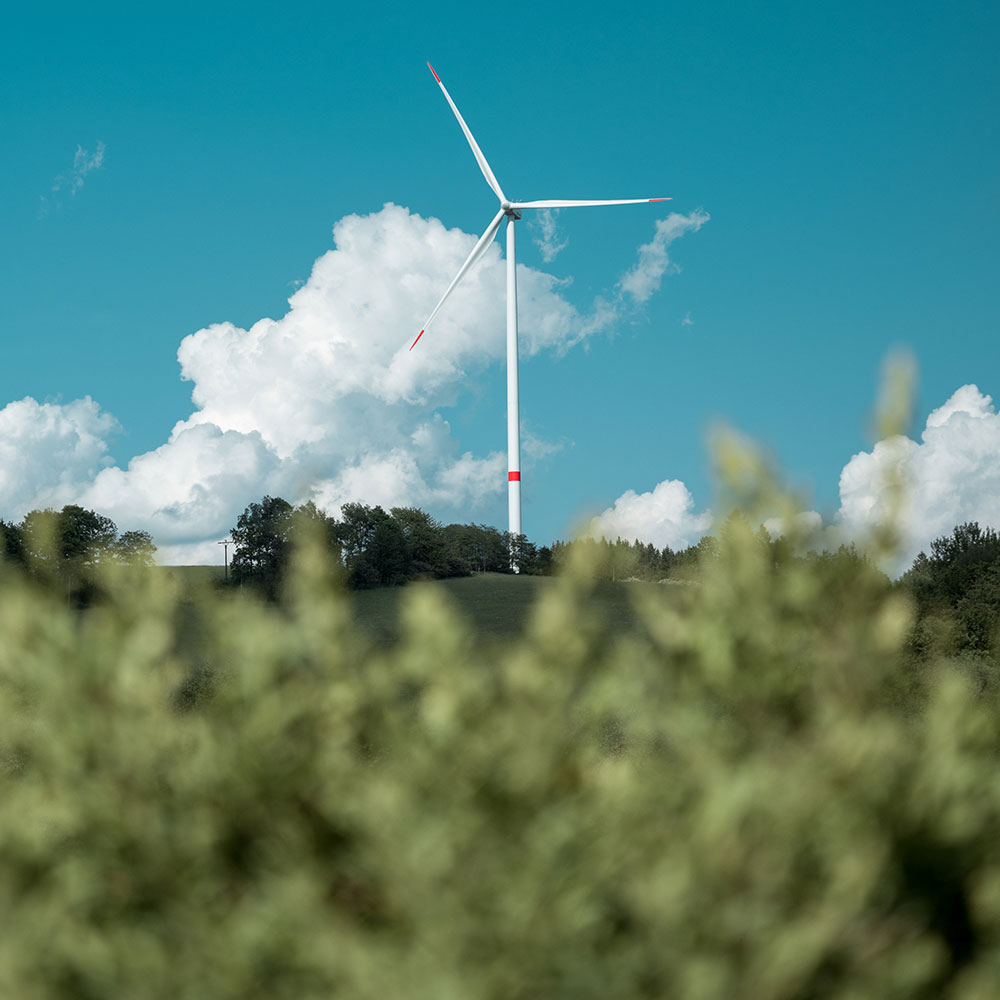 Green landscape and a wind turbine ISO Consultancy London