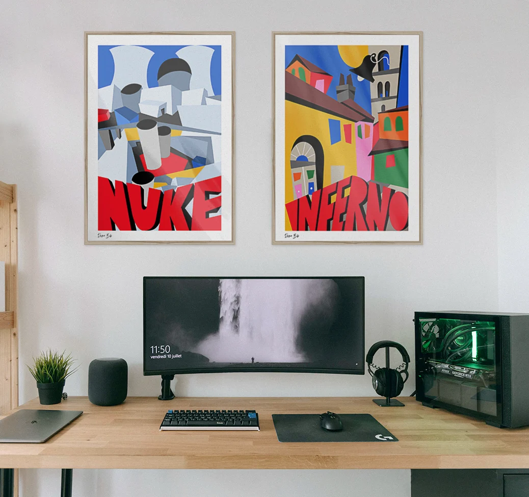 Modern computer setup with ultrawide monitor, keyboard, mouse, headphones, and two colorful framed Counter-Strike inspired posters above.