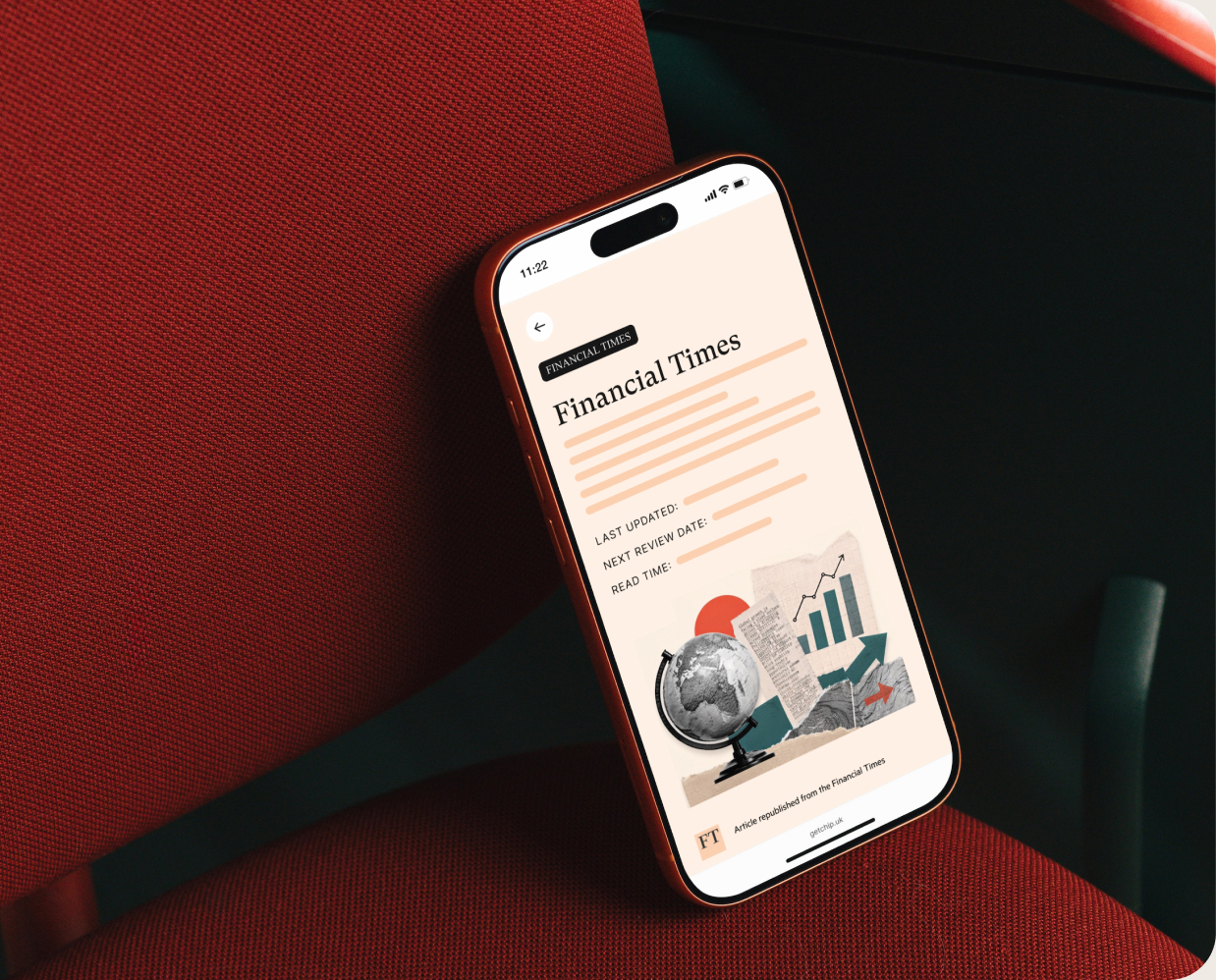 The Chip app showing a Financial Times article, on a phone resting on a red chair