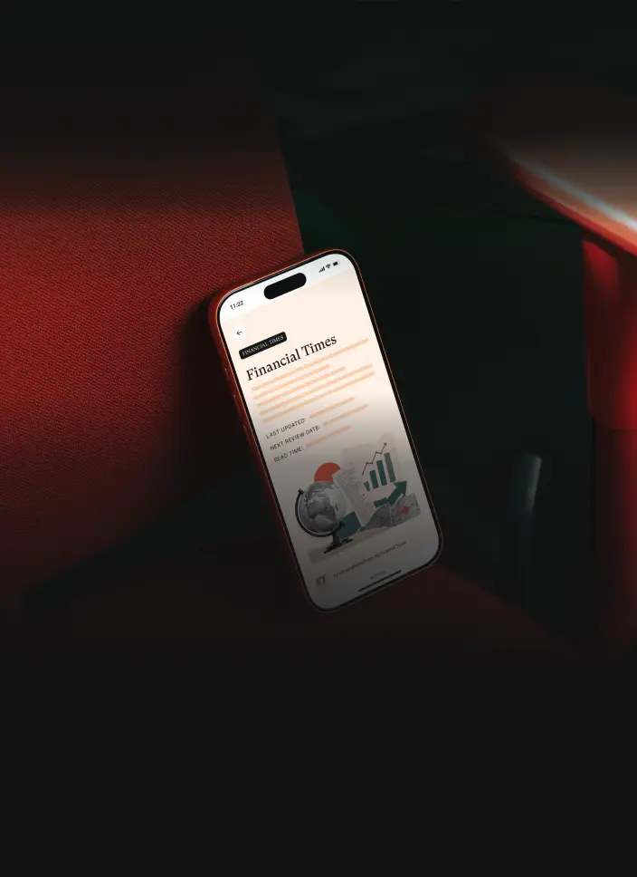 The Chip app showing a Financial Times article, on a phone resting on a red chair