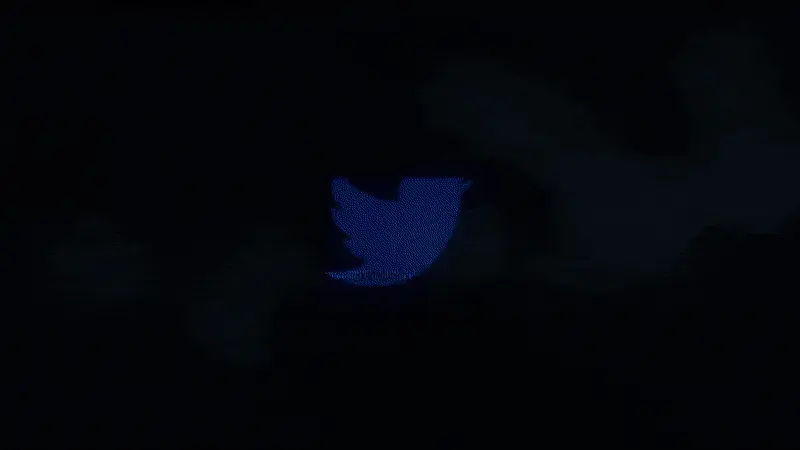 GIF image of the "X" logo flashing in & out with a static effect on a black background