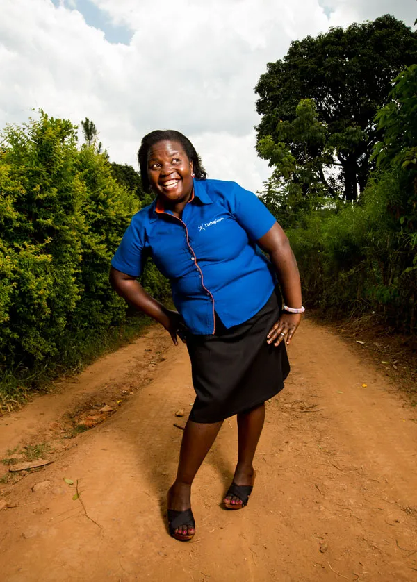 Community healthcare worker leaning to her left and smiling.
