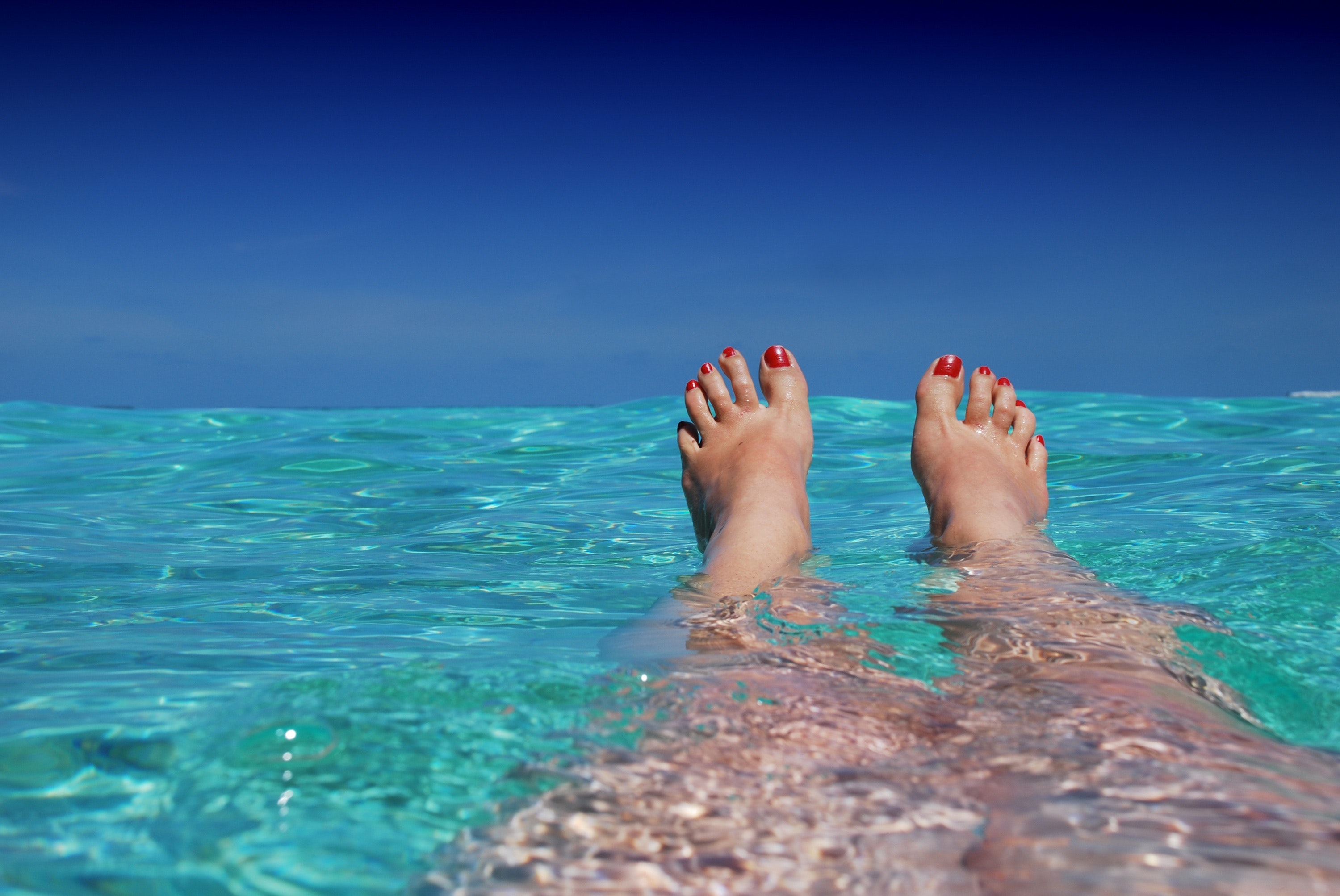 Photo of feet in the ocean