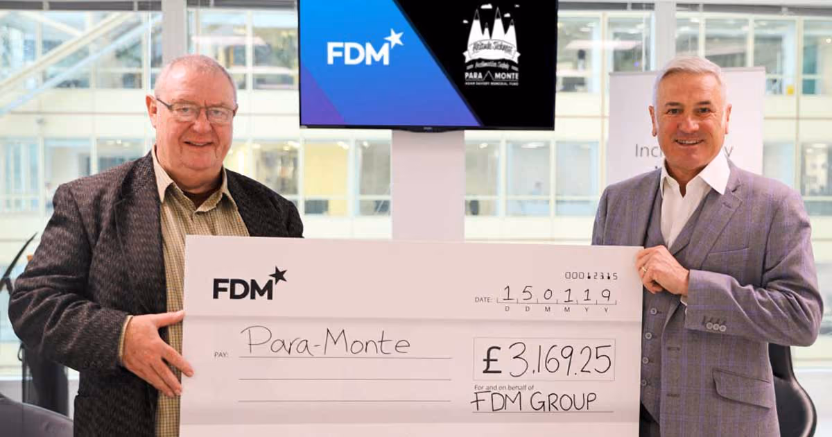 Picture of Chris receiving the donation from FDM