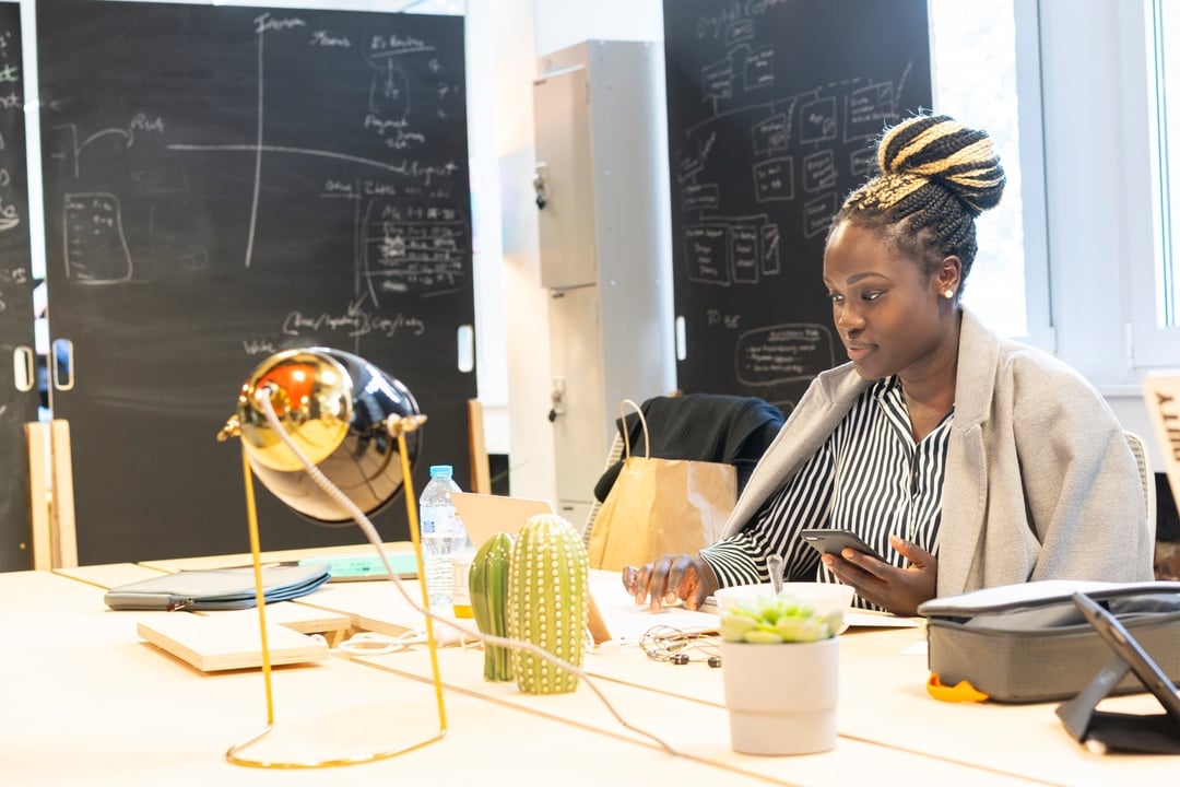woman working in coworking space with chalkboards