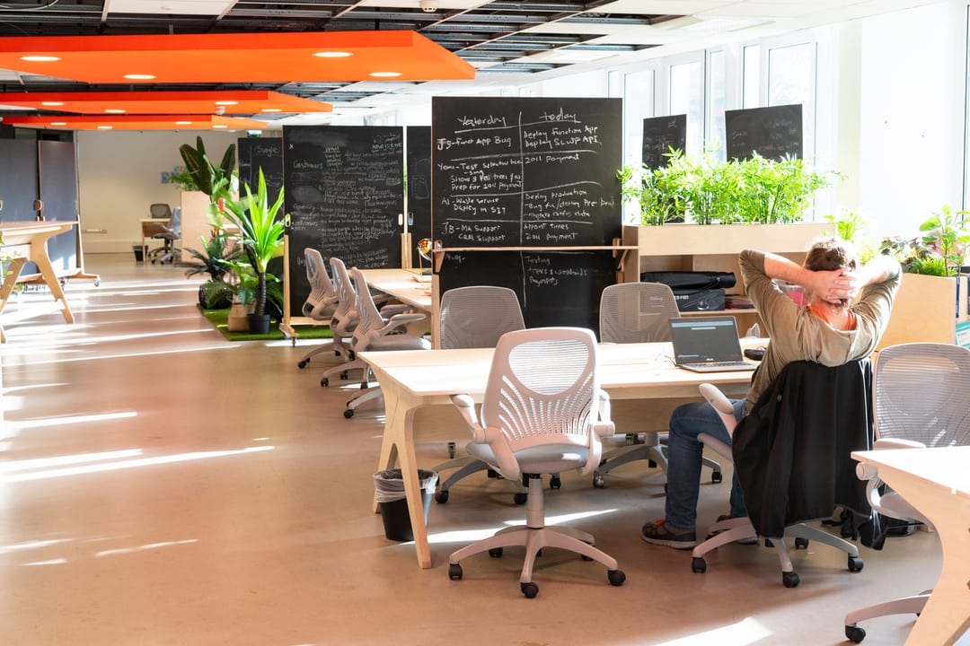 Man working at laptop in bright space