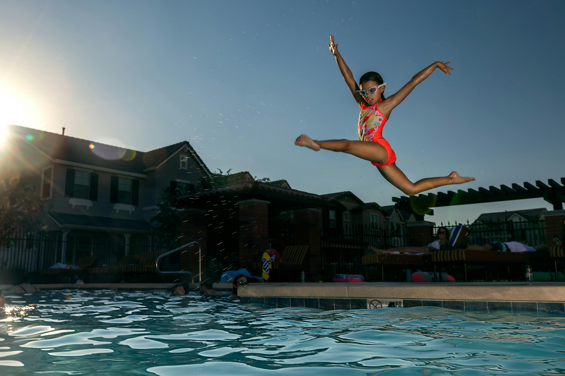 A girl jumping in a pool