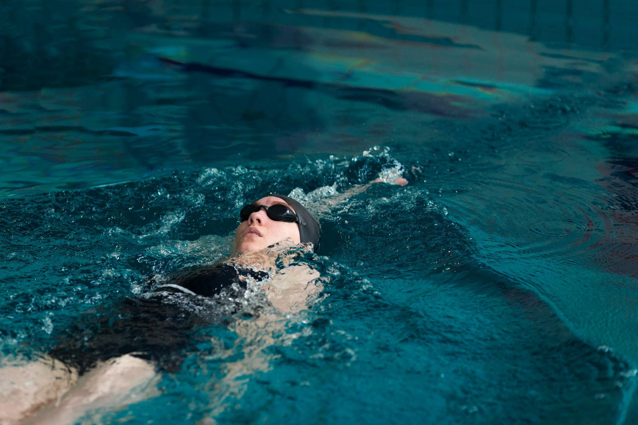 Competitive swimmer in a backstroke position underwater