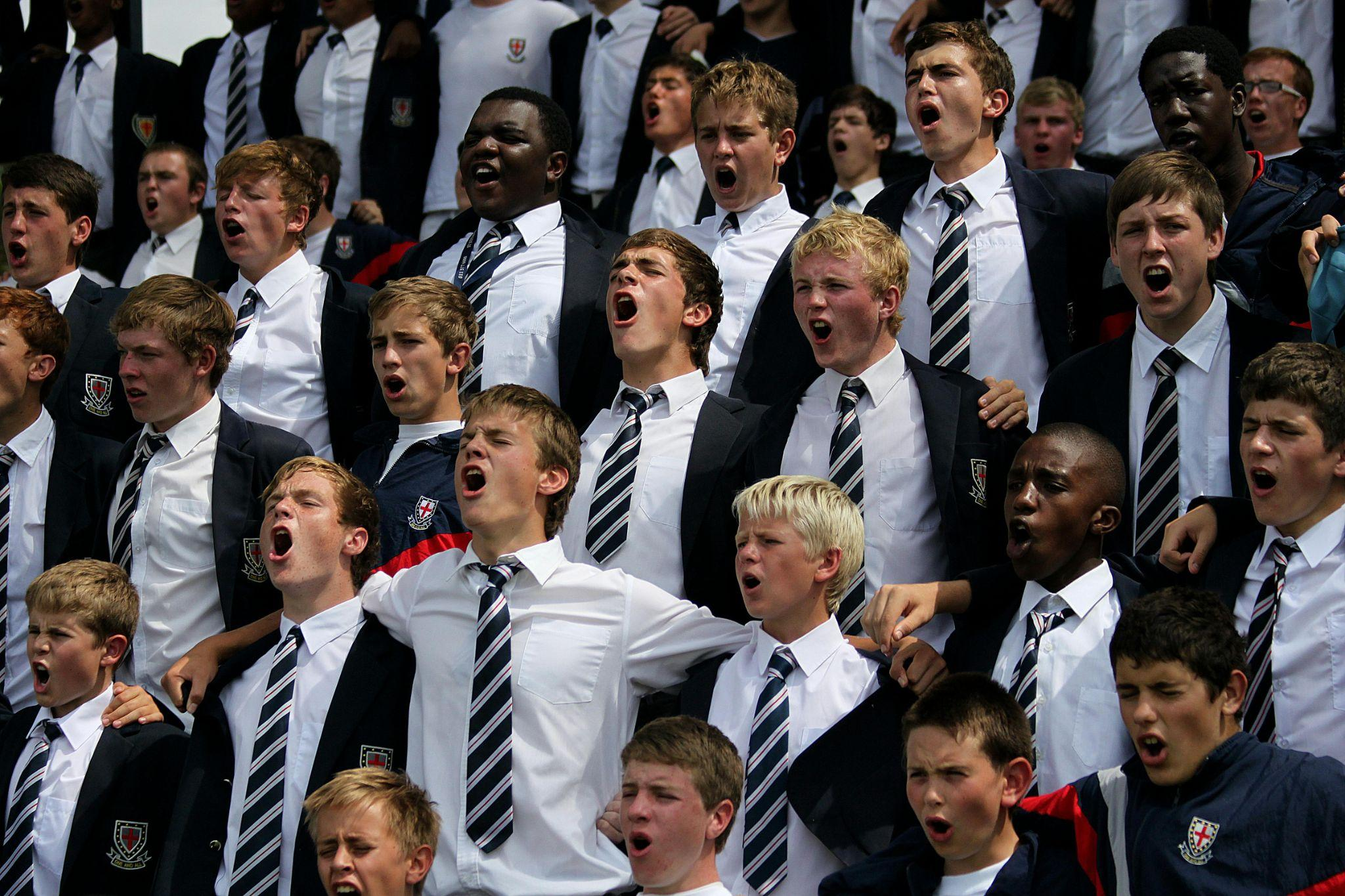 Large group of students wearing formal school uniform jackets and ties